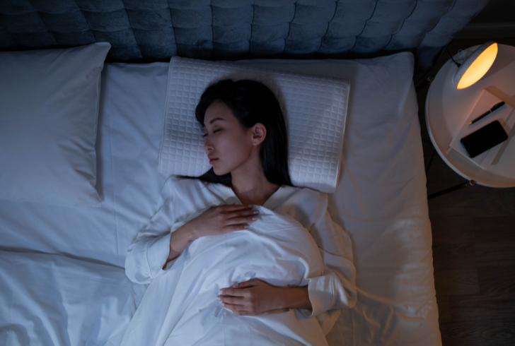 Woman Sleeping on a Bed