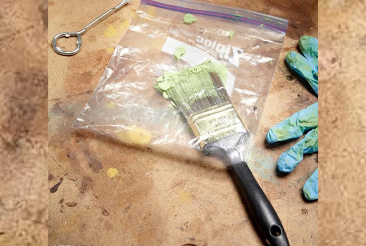 Paintbrush wrapped tightly in a plastic bag