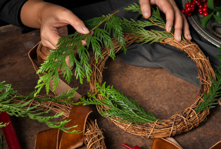 Grapevine wreath base with greenery