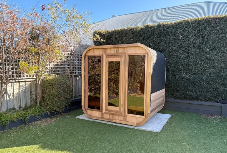 Compact cube sauna in small garden